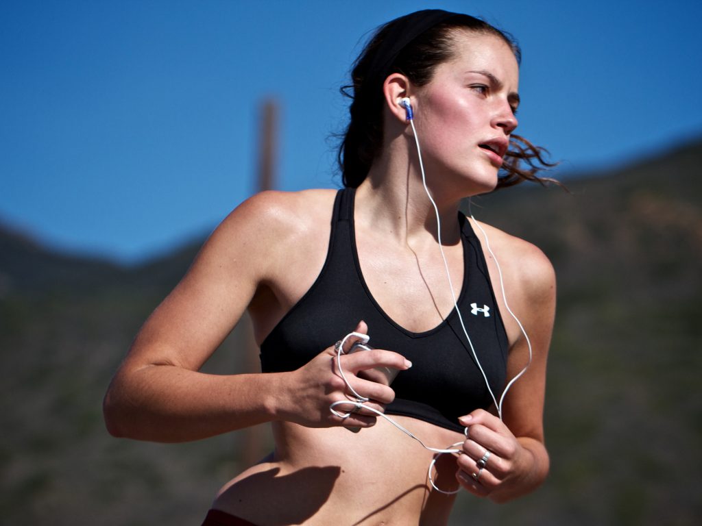 спортсменка слушает музыку на пробежке